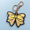 SMO Ceramics Purple + Yellow Striped Bow Bag Charm Hot